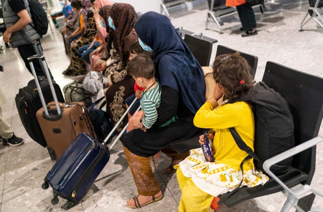 <p>Related: Afghan refugees wait to be processed after arriving on an evacuation flight from Afghanistan, at Heathrow Airport, London on August 26, 2021</p>