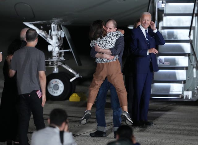 <p>Evan Gershkovich greets his mother Ella Milman as Biden looks on after WSJ reporter landed back on US soil </p>