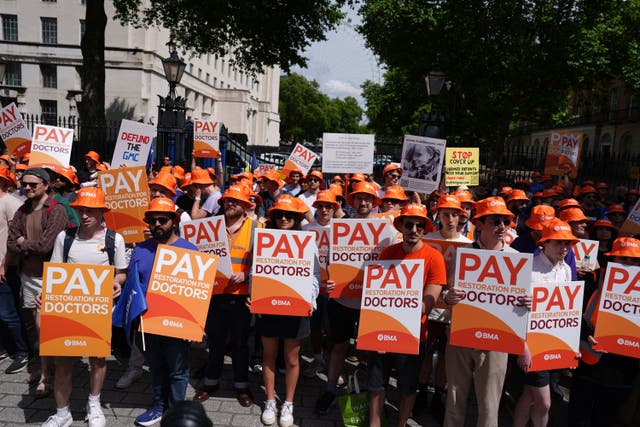 <p>Junior doctors protest opposite Downing Street last year</p>