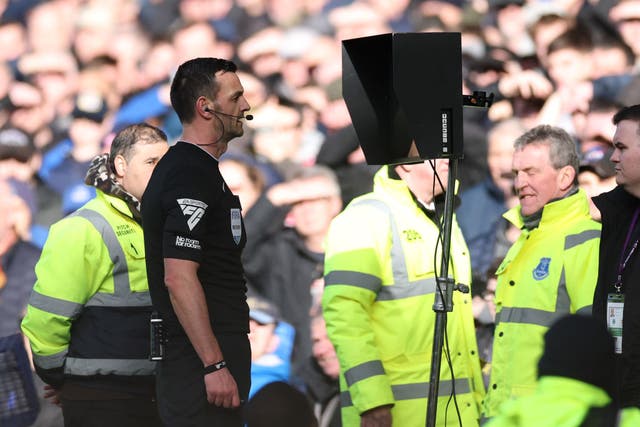 <p> Match Referee, Andrew Madley is pictured consulting the Video Assistant Referee (VAR)</p>