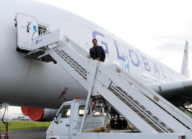 <p>Start up: James Asquith, founder of Global Airlines, on the steps of one of his Airbus A380 aircraft</p>