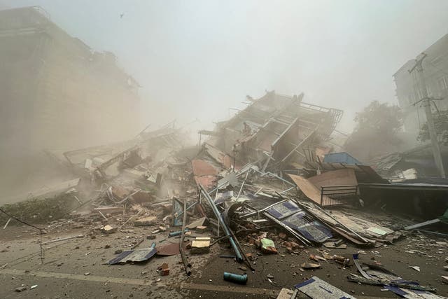 <p>People inspect the debris of a collapsed building in Mandalay on March 28, 2025, after an earthquake</p>