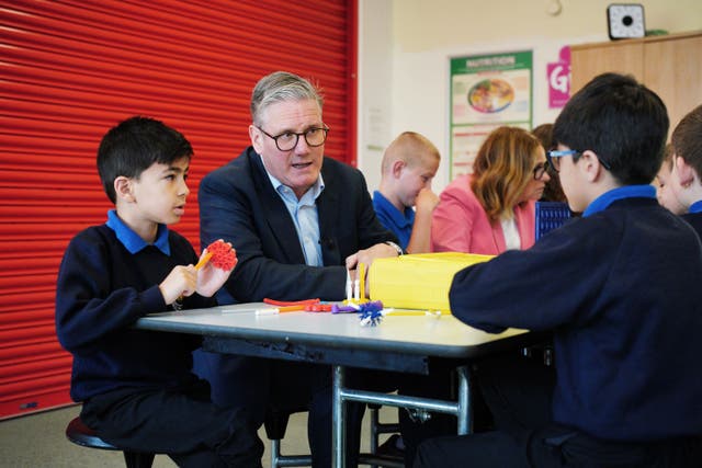 <p>Keir Starmer speaks to children during a visit to St Michael’s Junior School in Bath following the rollout of 750 new free breakfast clubs across England</p>