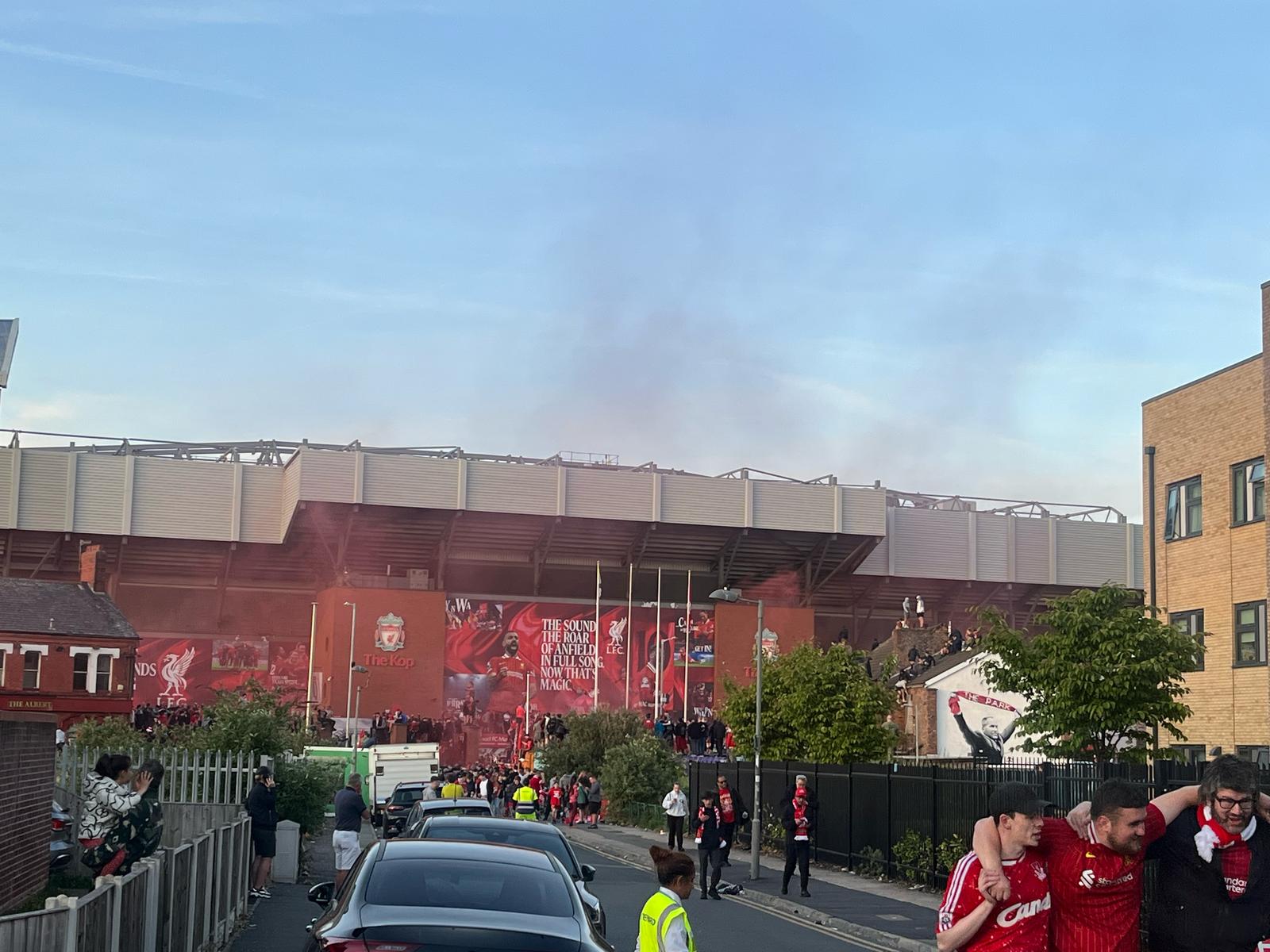 Red mist still drifted in the sky after full-time as one fan was held up by his two friends