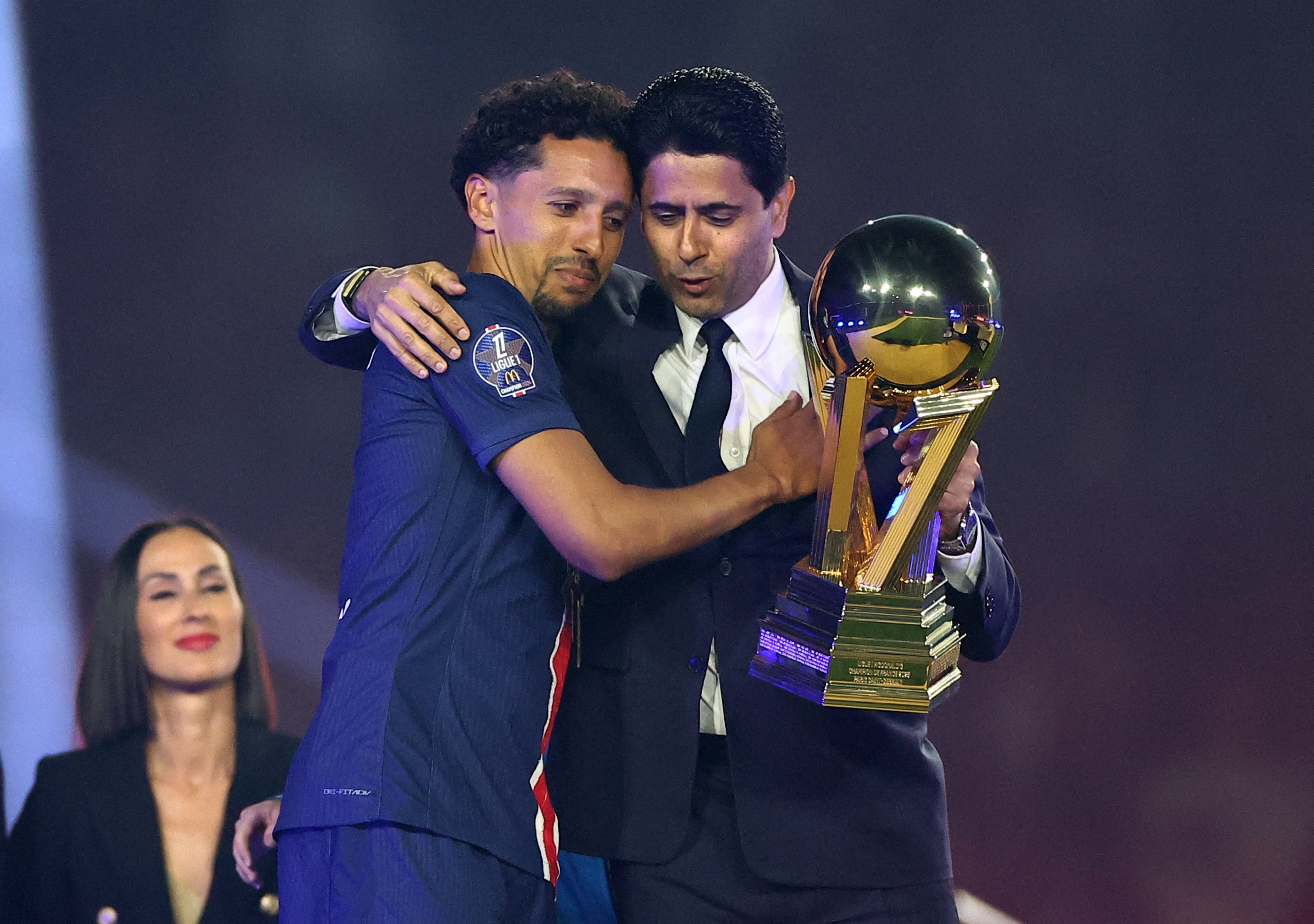 PSG president Nasser Al-Khelaifi presents the trophy to Marquinhos