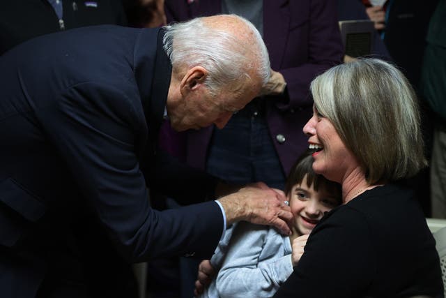 <p>Former former US president Joe Biden tickles a child during a campaign </p>