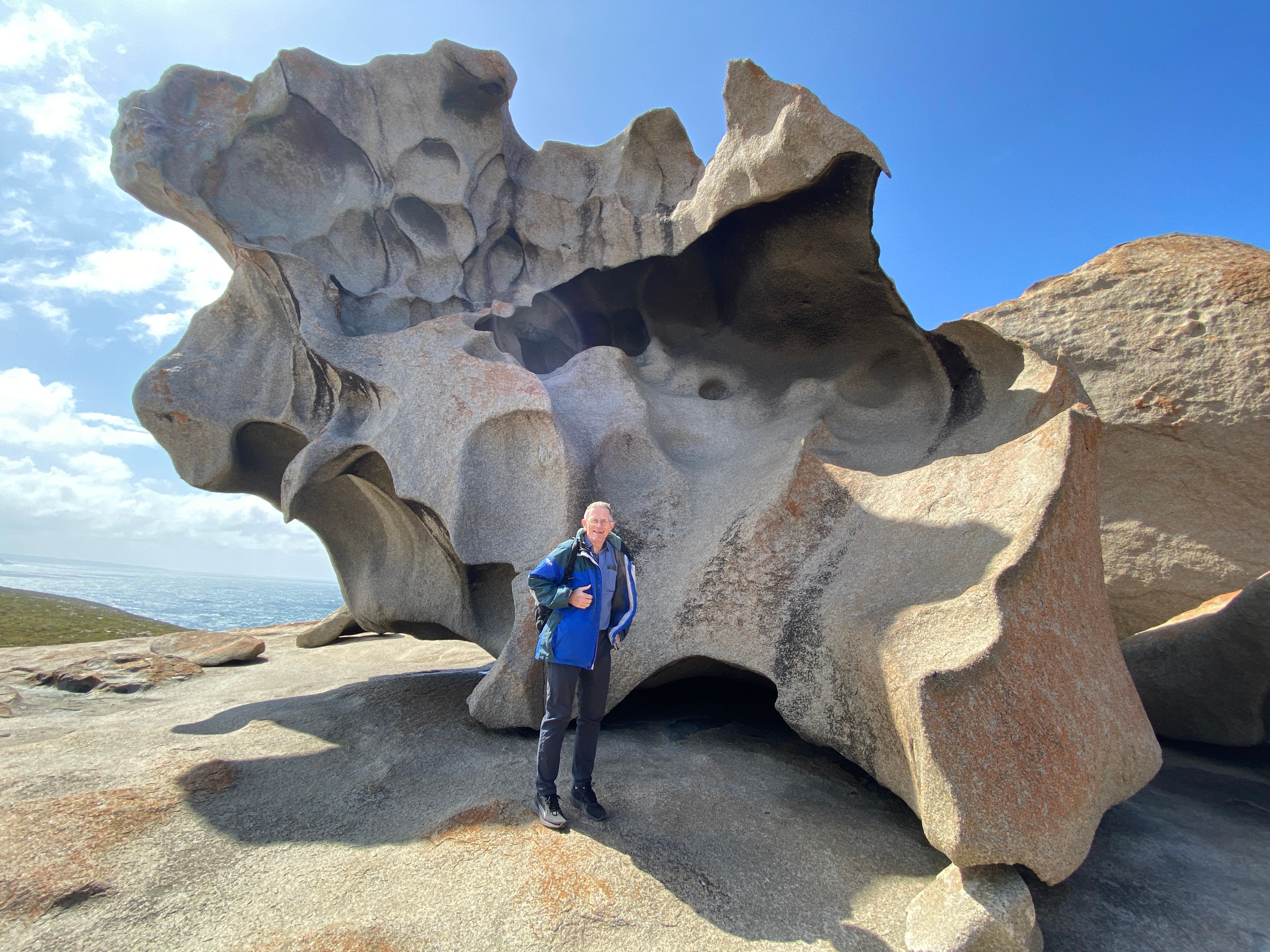 Simon stands in front of the weirdly sculpted Remarkable Rocks on the island