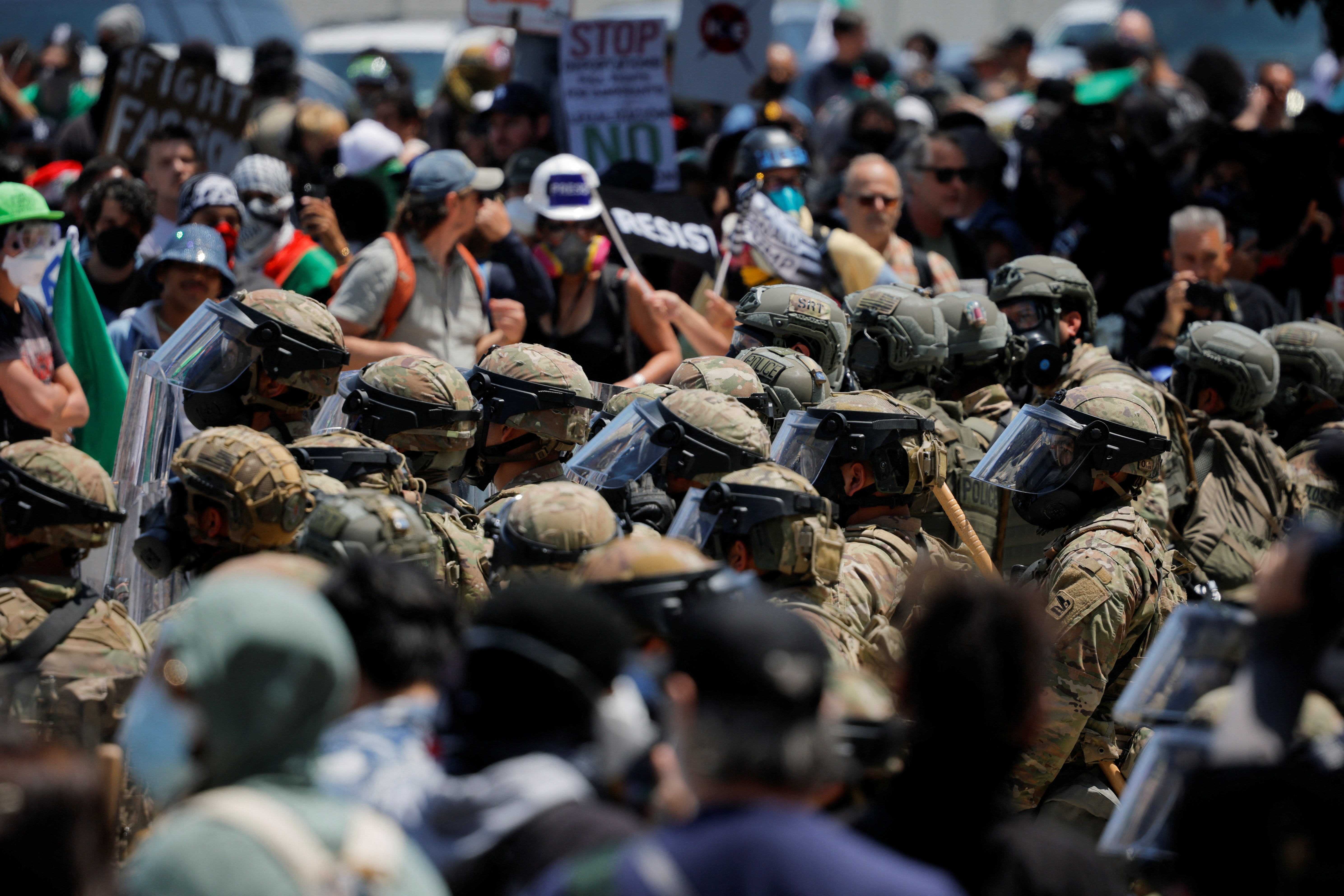 Demonstrators gather to protest against federal immigration sweeps, as members of the California National Guard stand outside the Edward R. Roybal federal building in Los Angeles