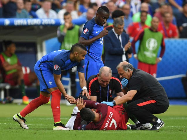 Dimitri Payet checks on Cristiano Ronaldo after his heavy challenge